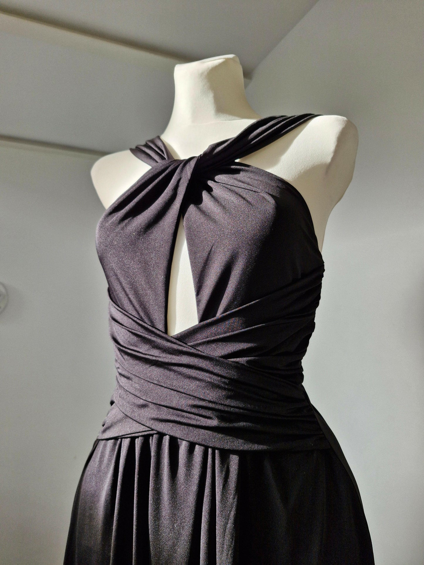 Long black party dress with elegant neckline for guests