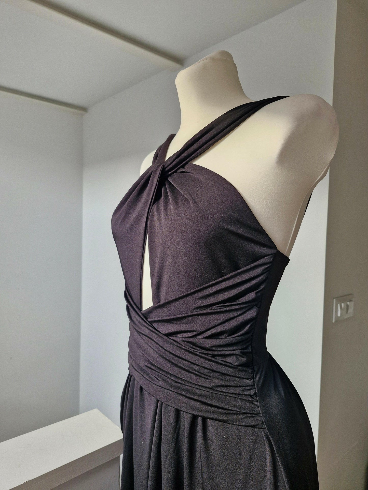 Long black party dress with elegant neckline for guests