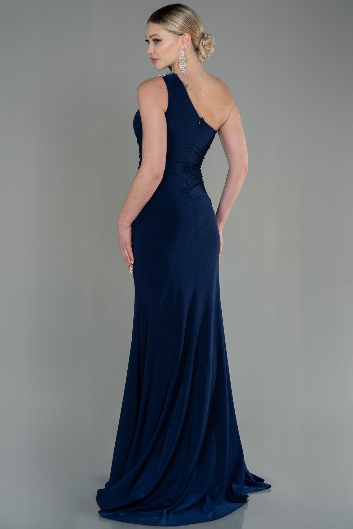 Asymmetrical navy blue guest dress with slit and silver detail