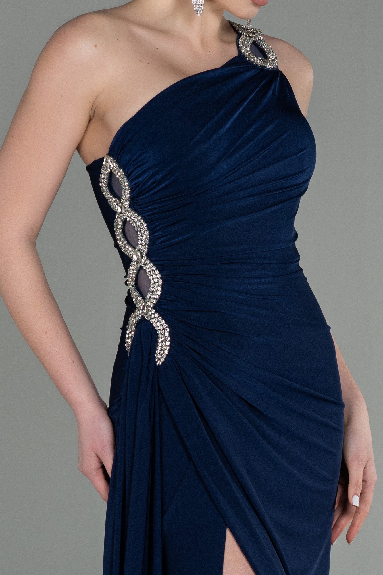 Asymmetrical navy blue guest dress with slit and silver detail