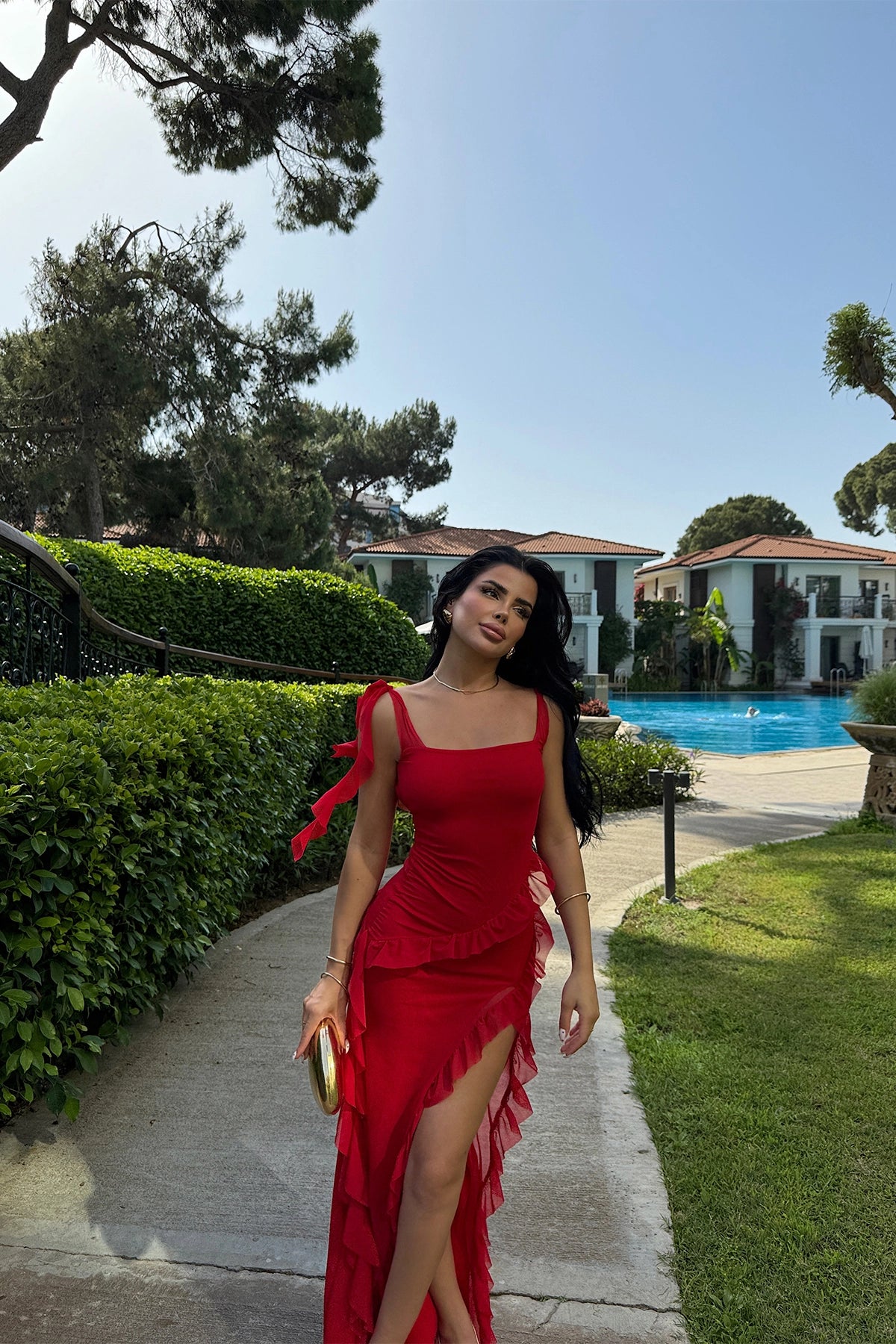 Long red dress with slit, ruffles, and tulle fabric