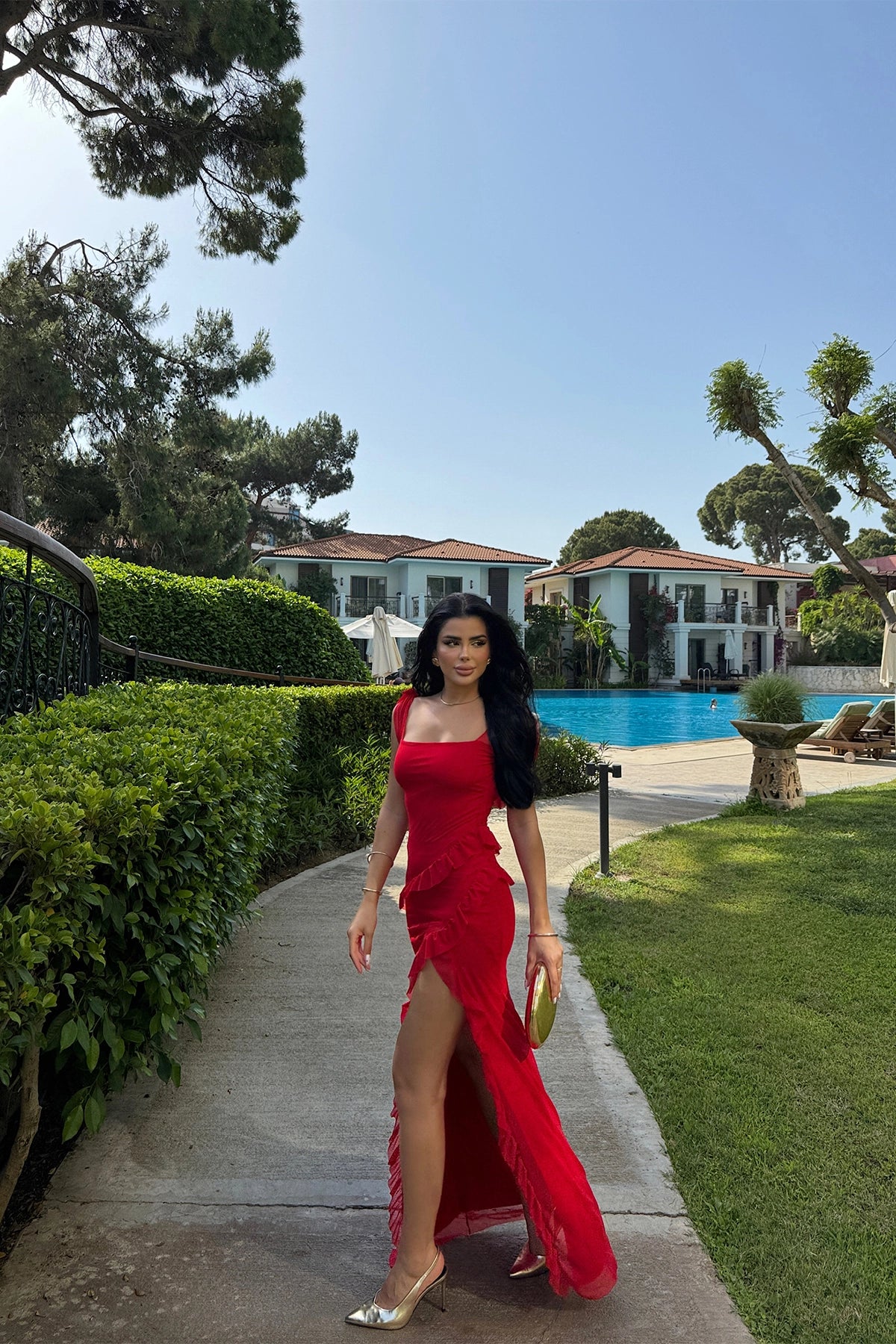 Long red dress with slit, ruffles, and tulle fabric