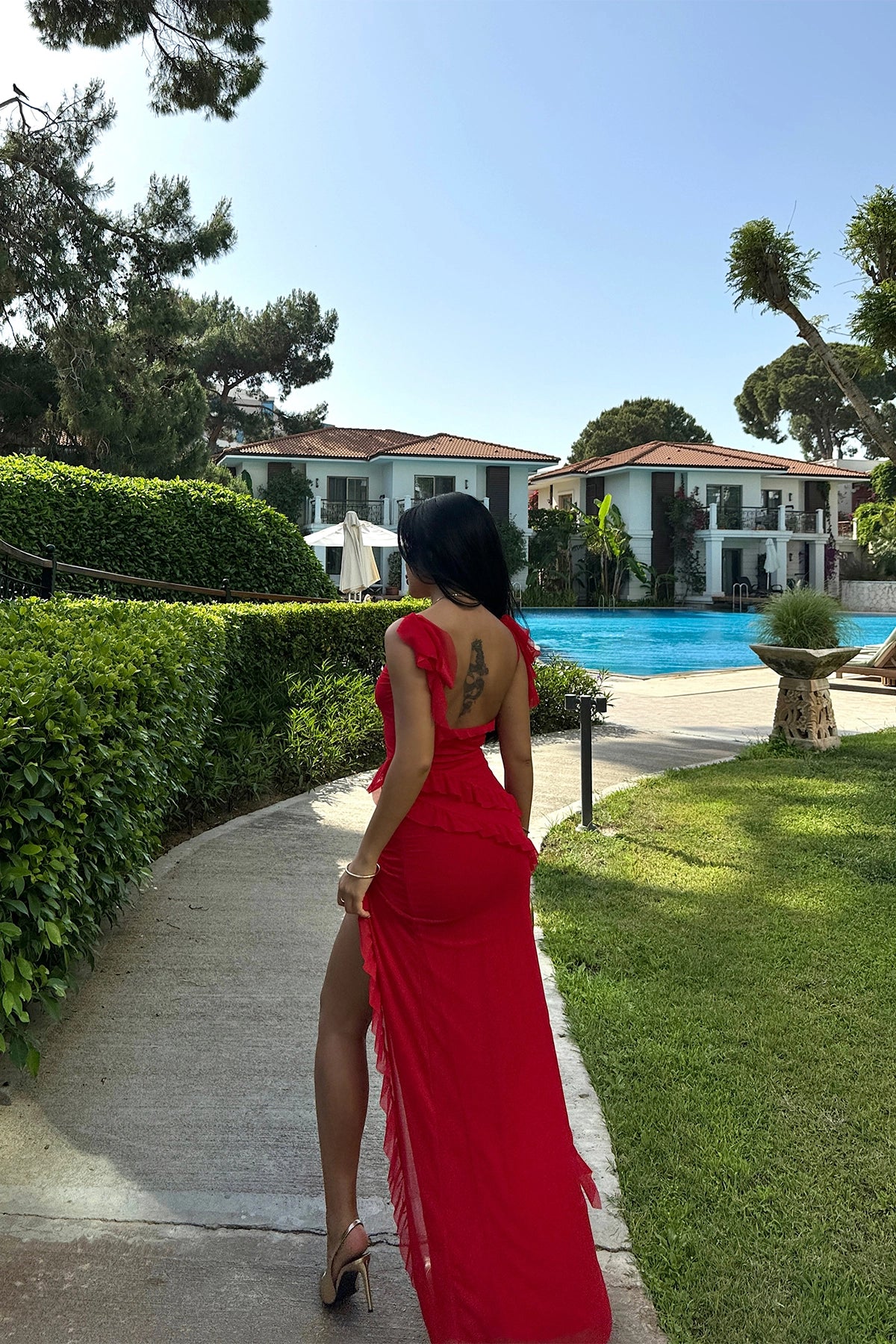 Long red dress with slit, ruffles, and tulle fabric