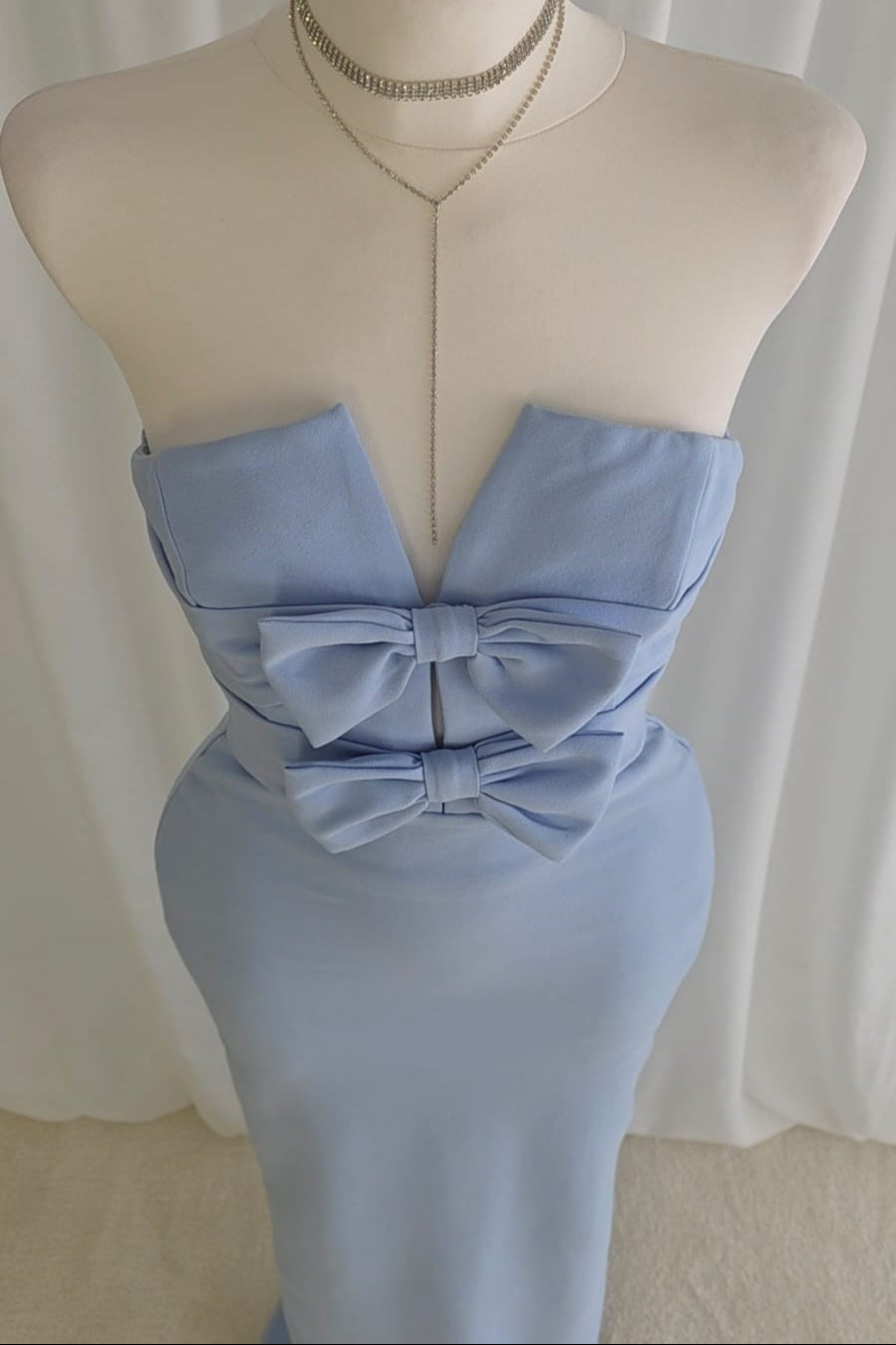 Long pastel blue dress with bow detail and back slit