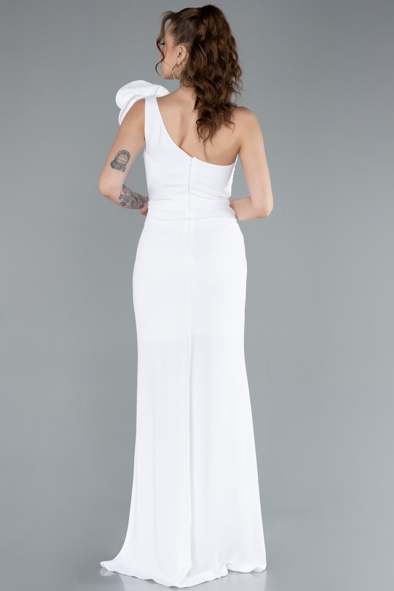 Asymmetrical white wedding dress with flower detail on the shoulder