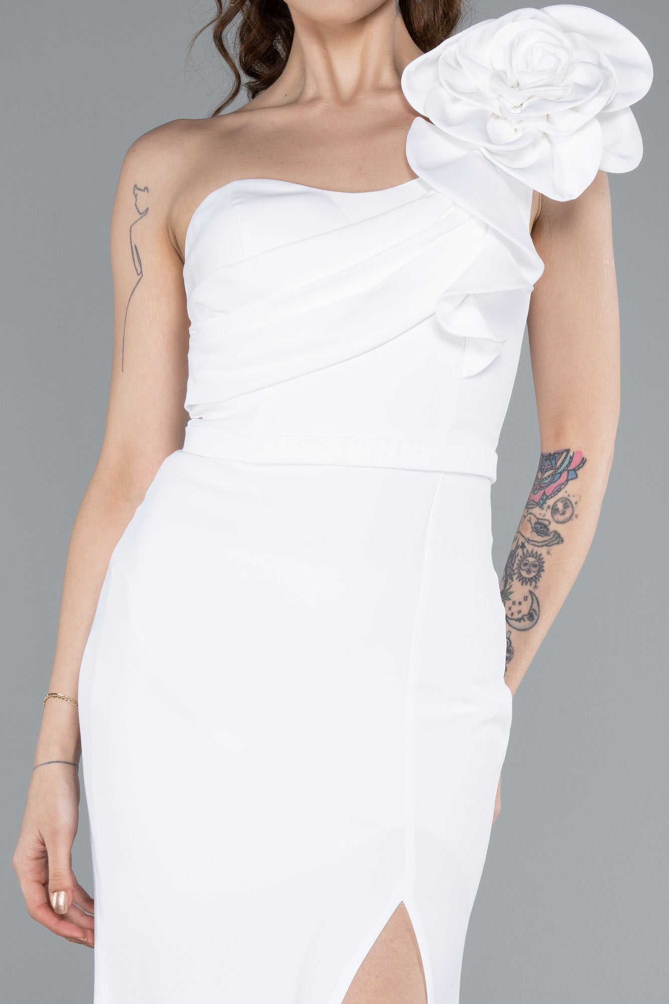 Asymmetrical white wedding dress with flower detail on the shoulder