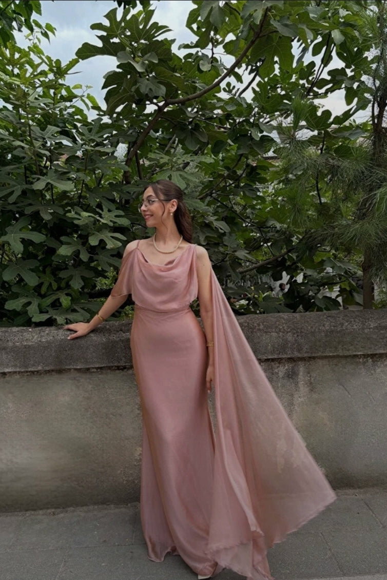 Dusty pink dress with cape on one sleeve and draped neckline