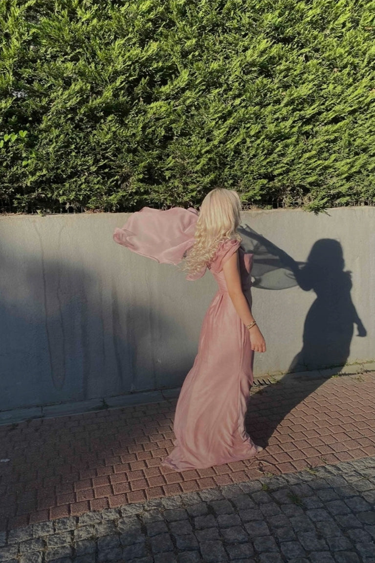 Dusty pink dress with cape on one sleeve and draped neckline