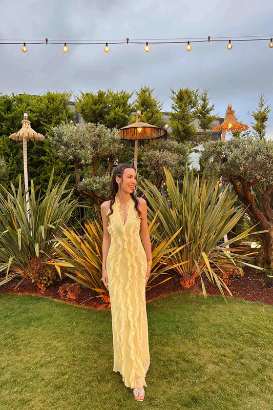 Pastel yellow dress with ruffles and halter neck