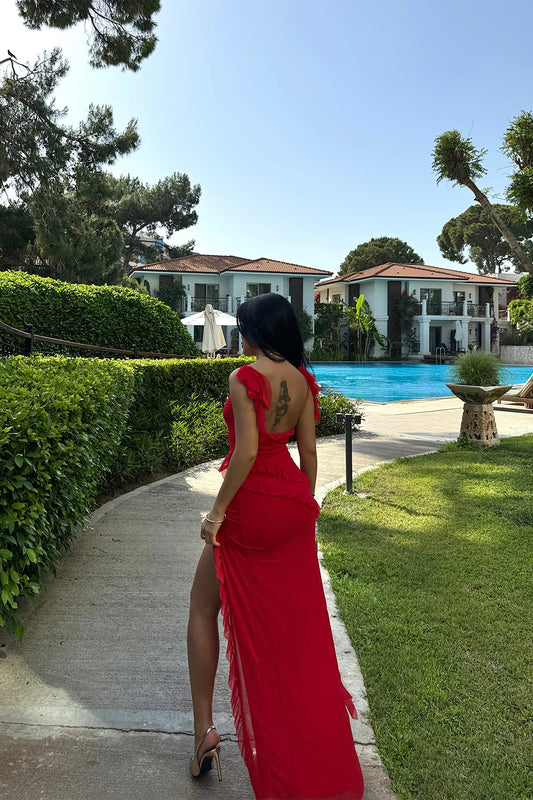 Long red dress with slit, ruffles, and tulle fabric