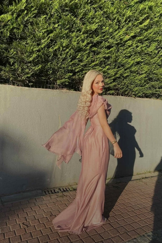 Dusty pink dress with cape on one sleeve and draped neckline