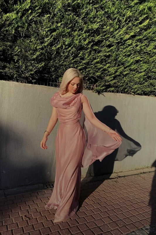 Dusty pink dress with cape on one sleeve and draped neckline